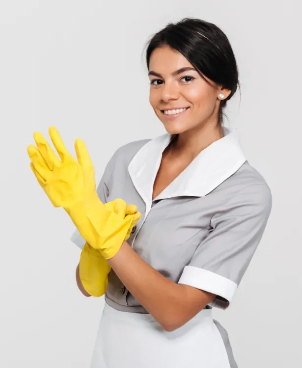 Smiling cleaning professional putting on bright yellow rubber gloves