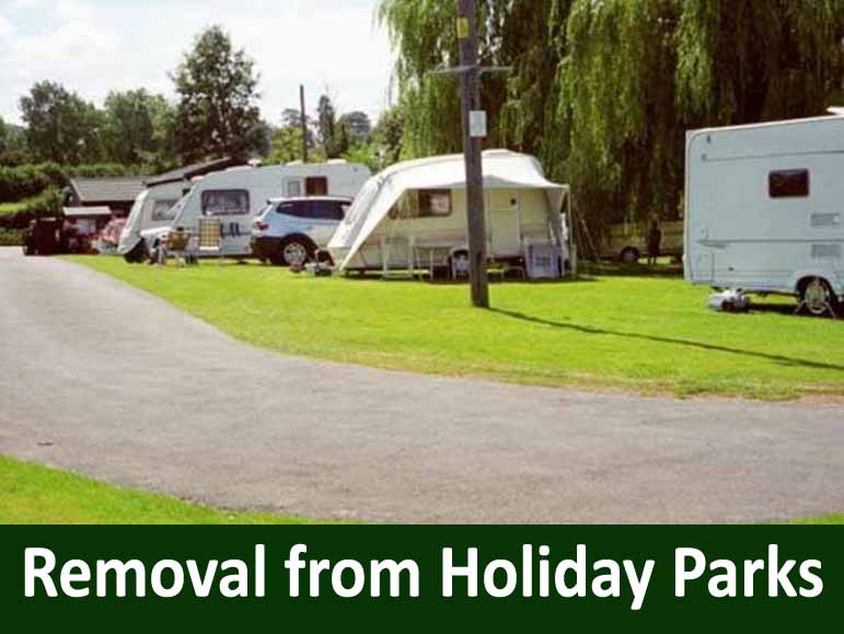Row of caravans and a car parked on a grassy holiday park, with trees in the background and a banner reading 'Removal from Holiday Parks' at the bottom.